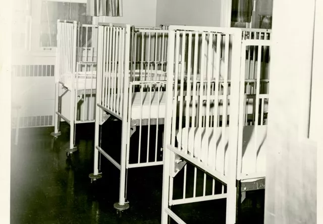 Three infant cribs in a hospital setting
