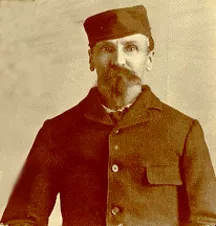 An archival photo of Alfred Packer in a hat and jacket