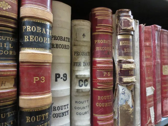 A row of antique books with the words probate records on the spine.