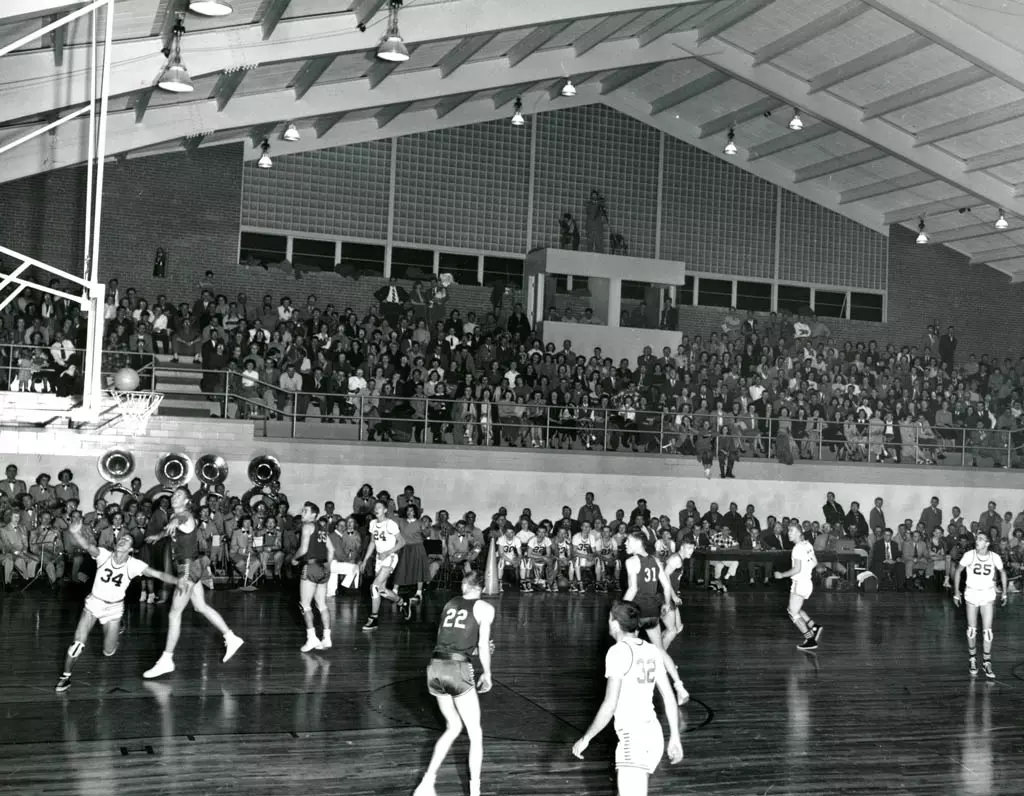 A black and white photo of a basketball game in a college gymnasium. Image courtesy of the Colorado State Archives.